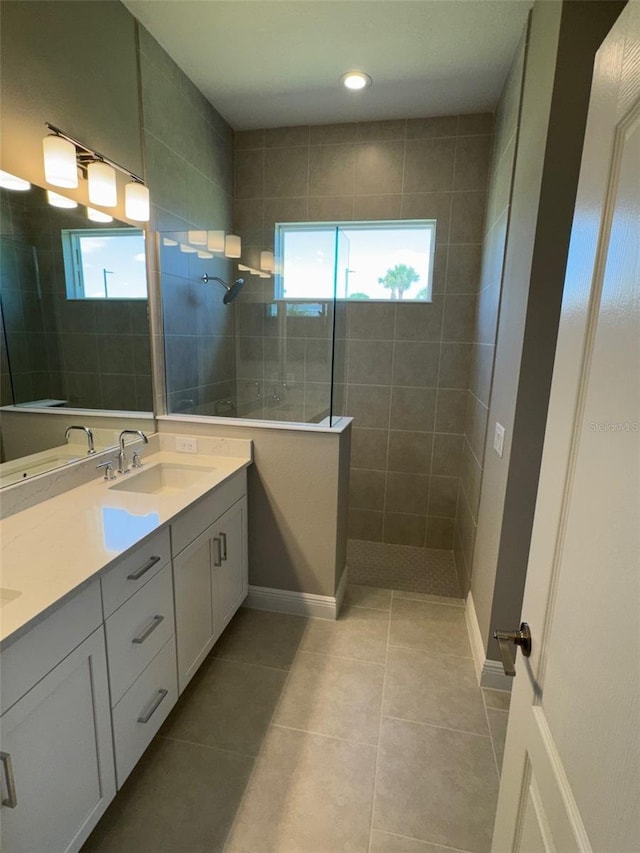 full bathroom featuring a healthy amount of sunlight, a sink, a walk in shower, and double vanity