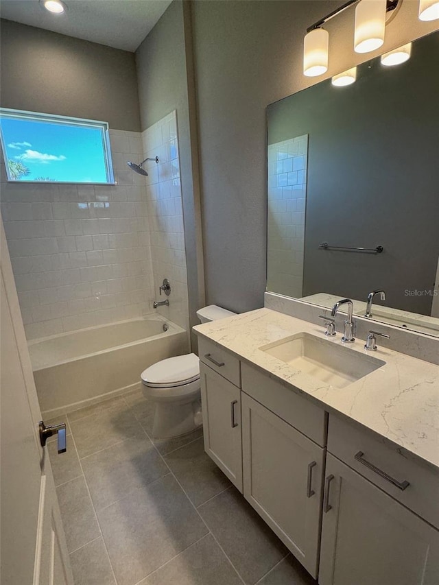 full bath with tile patterned flooring, tub / shower combination, toilet, and vanity