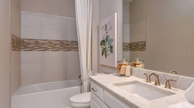 bathroom featuring shower / bath combination with curtain, vanity, and toilet