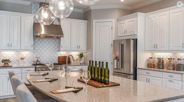 kitchen featuring ventilation hood, an island with sink, white cabinetry, and high quality fridge