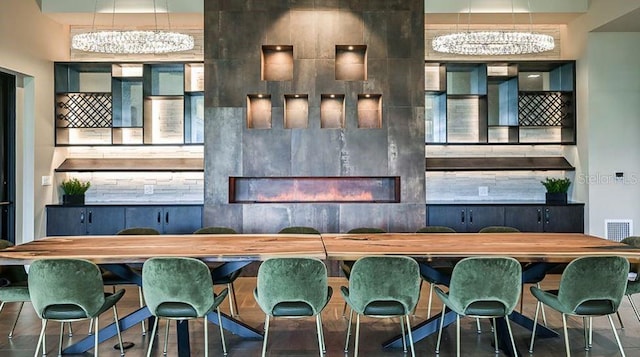 interior space with visible vents and a glass covered fireplace