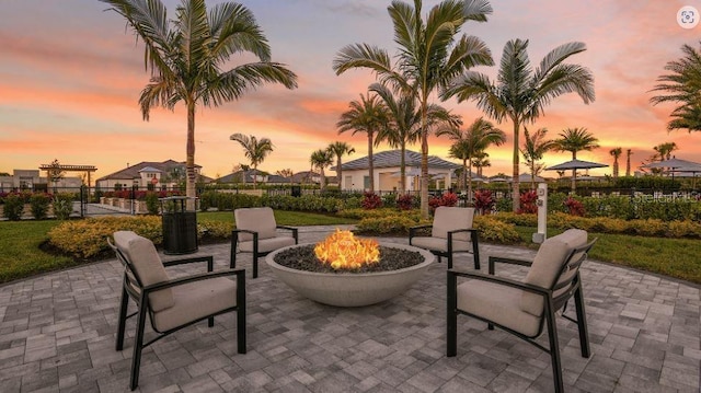 view of patio featuring an outdoor fire pit and fence