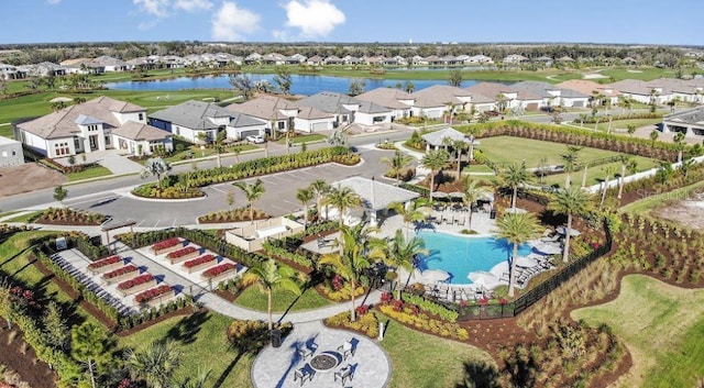 drone / aerial view featuring a water view, a residential view, and golf course view