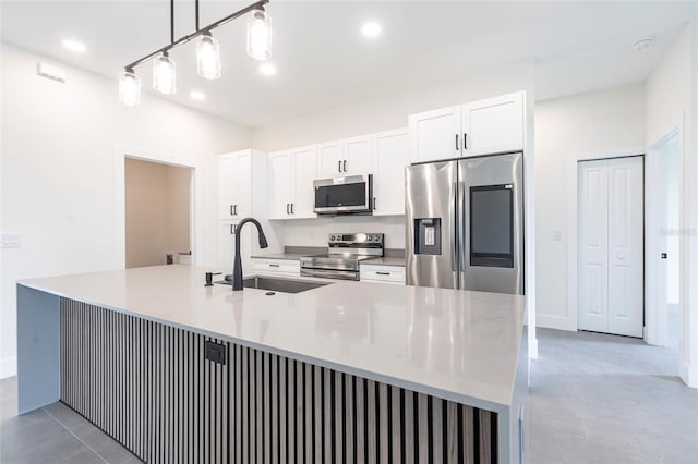 kitchen with stainless steel appliances, a sink, white cabinets, recessed lighting, and light countertops