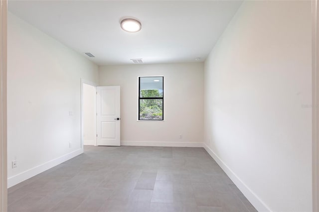 unfurnished room featuring baseboards