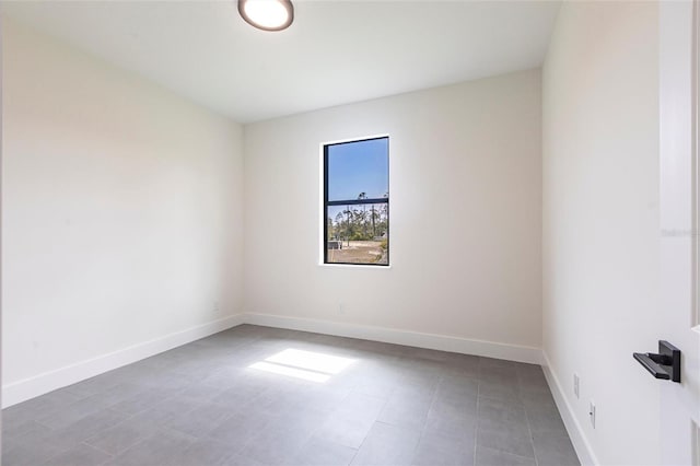 spare room featuring baseboards