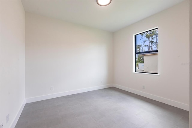 unfurnished room featuring baseboards