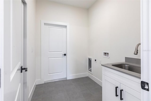 clothes washing area featuring electric dryer hookup, hookup for a washing machine, baseboards, and cabinet space