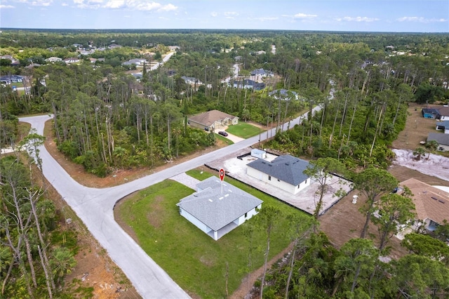 aerial view of property and surrounding area with a forest