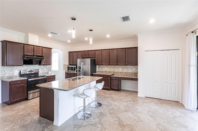 kitchen featuring visible vents, stainless steel appliances, dark brown cabinetry, and a sink