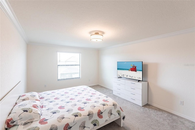 bedroom featuring baseboards, ornamental molding, a textured ceiling, and light colored carpet