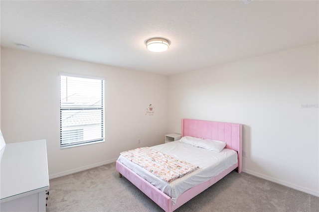 bedroom with carpet and baseboards