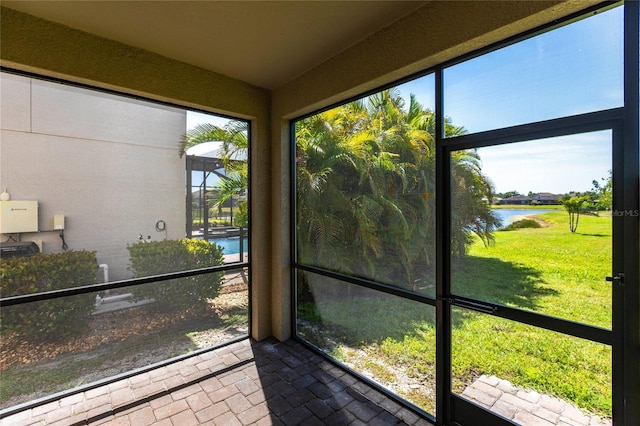 unfurnished sunroom with a water view