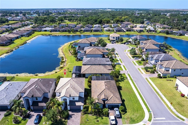 birds eye view of property featuring a water view and a residential view