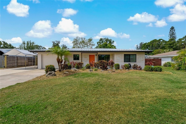 2708 Fort Worth St, Sarasota, FL 34231 - ranch-style home featuring an attached garage, driveway, and a metal roof