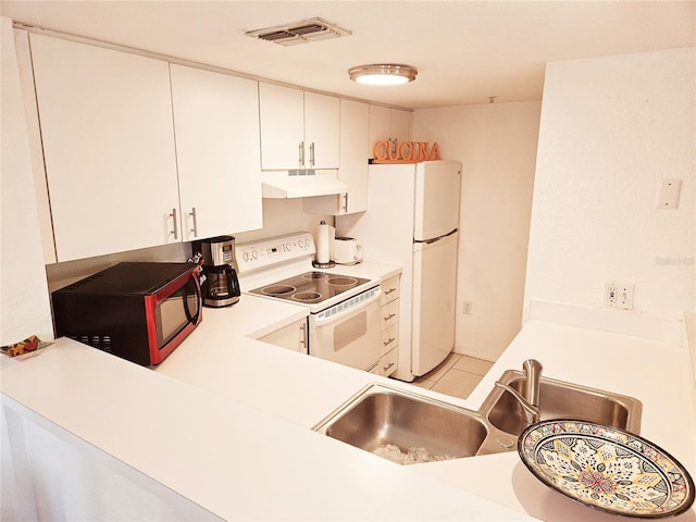 kitchen with under cabinet range hood, white appliances, light countertops, a sink, and white cabinets