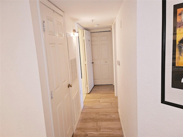 hallway with light wood-style floors