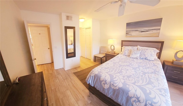 bedroom featuring wood finished floors, a ceiling fan, and a closet