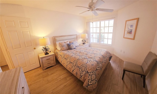 bedroom featuring light wood finished floors and a ceiling fan