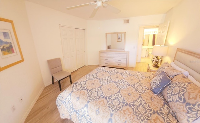 bedroom with wood finished floors, a closet, baseboards, and ceiling fan