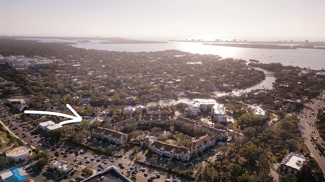 aerial view of property and surrounding area featuring a nearby body of water