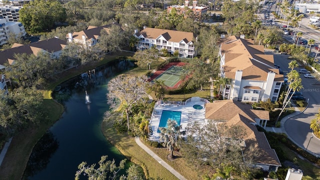 aerial overview of property's location with a nearby body of water and a pool area
