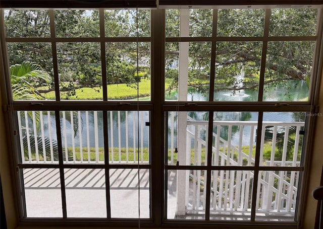850 S Tamiami Trl Unit 529, Sarasota, FL 34236 - doorway to outside with a water view, view of wooded area, and healthy amount of natural light