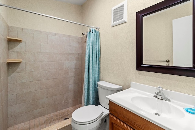 3909 40th St W, Bradenton, FL 34205 - bathroom with vanity, a tile shower, toilet, and visible vents