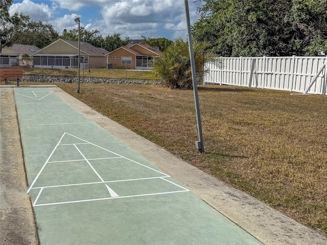 3909 40th St W, Bradenton, FL 34205 - view of community featuring shuffleboard, a yard, and fence