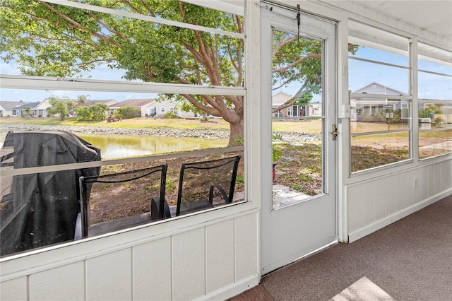 3909 40th St W, Bradenton, FL 34205 - entryway featuring a water view, baseboards, carpet flooring, and a residential view