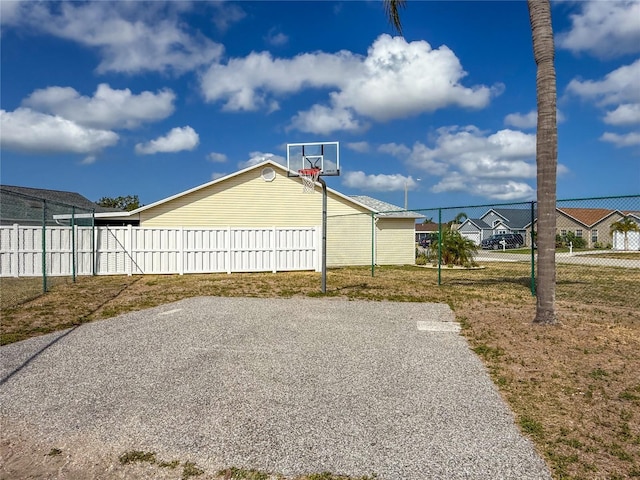 3909 40th St W, Bradenton, FL 34205 - view of sport court featuring fence, basketball court, and a lawn