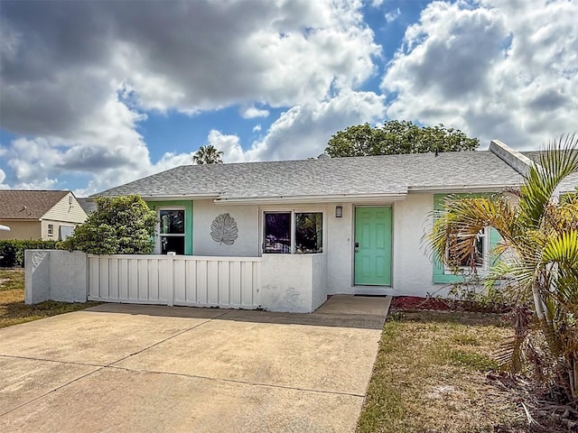3909 40th St W, Bradenton, FL 34205 - view of front of property featuring a shingled roof, stucco siding, and fence