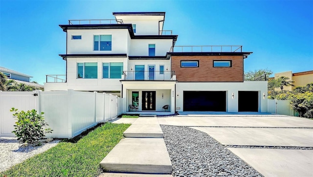 8800 Midnight Pass Rd, Sarasota, FL 34242 - view of front of property with stucco siding, a balcony, driveway, and an attached garage