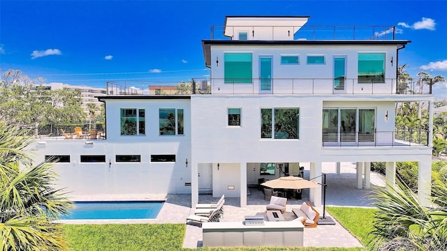 8800 Midnight Pass Rd, Sarasota, FL 34242 - back of property featuring a balcony, a patio area, solar panels, an outdoor pool, and an outdoor living space with a fire pit