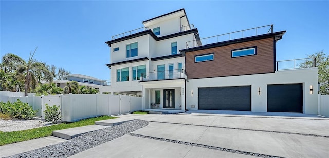 8800 Midnight Pass Rd, Sarasota, FL 34242 - view of front of home with a balcony, stucco siding, a garage, and driveway