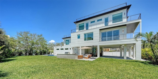8800 Midnight Pass Rd, Sarasota, FL 34242 - back of house featuring a patio, an outdoor hangout area, a lawn, and a balcony
