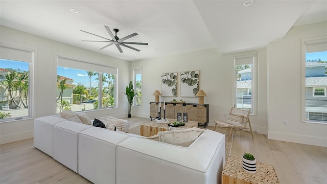 8800 Midnight Pass Rd, Sarasota, FL 34242 - living area featuring light wood-type flooring, a ceiling fan, and a fireplace