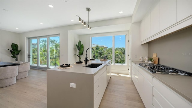 8800 Midnight Pass Rd, Sarasota, FL 34242 - kitchen featuring appliances with stainless steel finishes, plenty of natural light, light wood-type flooring, recessed lighting, and white cabinetry