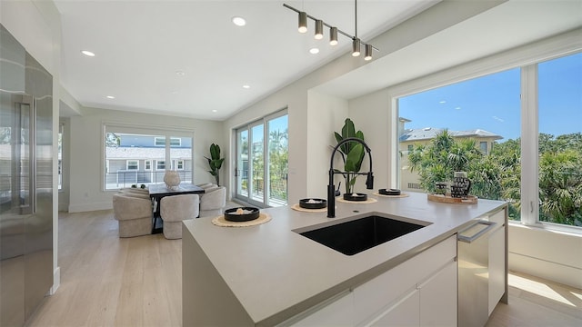 8800 Midnight Pass Rd, Sarasota, FL 34242 - kitchen featuring light wood finished floors, open floor plan, light countertops, recessed lighting, and white cabinets