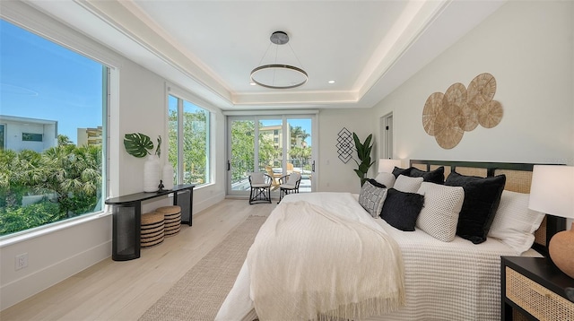 8800 Midnight Pass Rd, Sarasota, FL 34242 - bedroom with wood finished floors, access to outside, and a tray ceiling