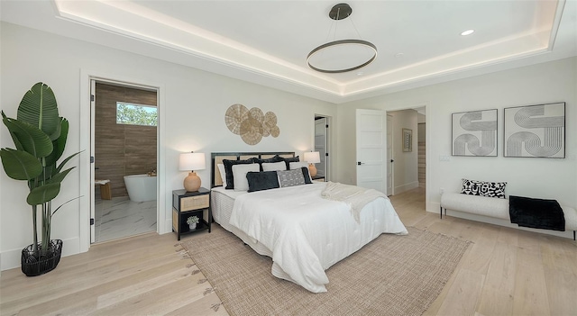8800 Midnight Pass Rd, Sarasota, FL 34242 - bedroom with a tray ceiling, light wood finished floors, connected bathroom, and recessed lighting