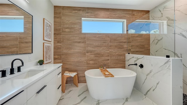 8800 Midnight Pass Rd, Sarasota, FL 34242 - full bath featuring plenty of natural light, marble tiled flooring, vanity, and a soaking tub
