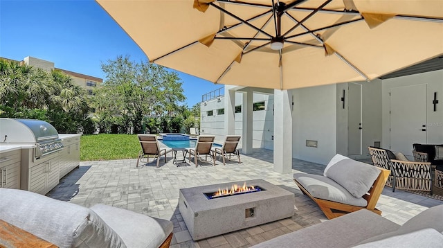 8800 Midnight Pass Rd, Sarasota, FL 34242 - view of patio / terrace with an outdoor kitchen, a pool, outdoor dining space, and an outdoor living space with a fire pit