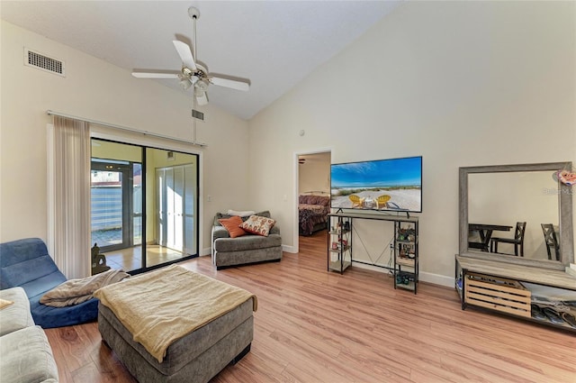 living room featuring visible vents, baseboards, wood finished floors, ceiling fan, and high vaulted ceiling