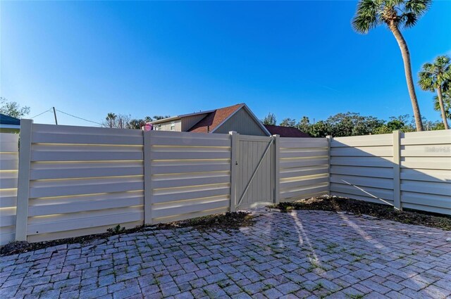 view of patio with fence and a gate