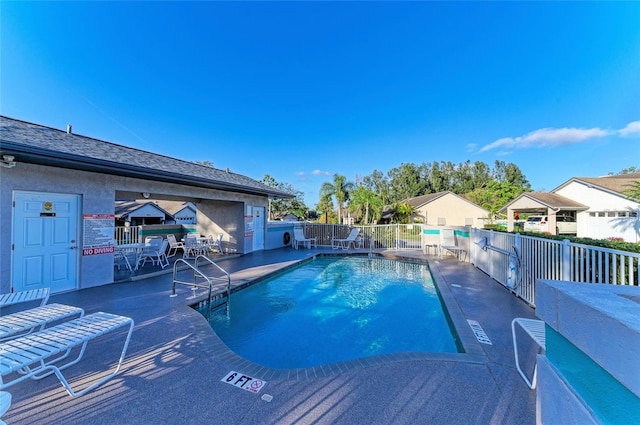pool with fence and a patio
