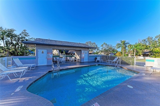 pool featuring fence and a patio