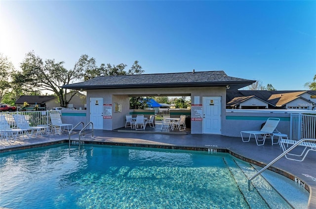 pool with fence and a patio area
