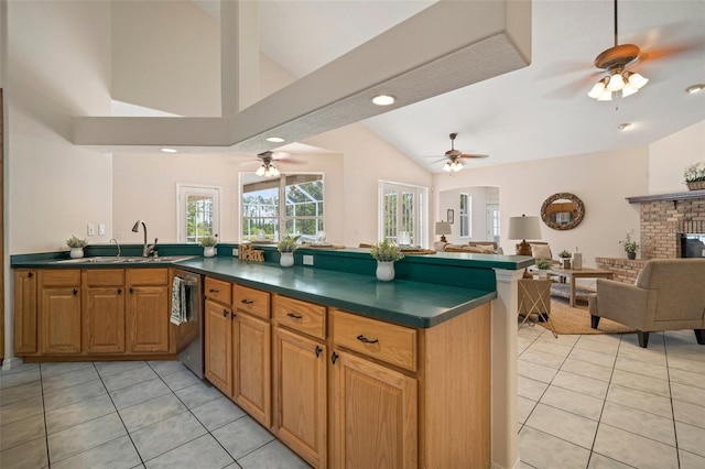 kitchen with open floor plan, vaulted ceiling, dark countertops, and a ceiling fan