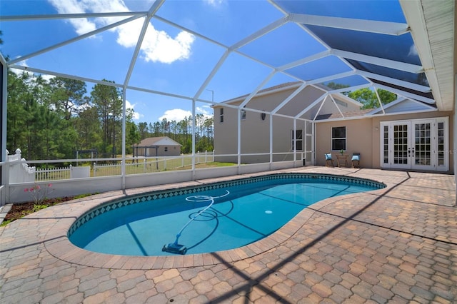 outdoor pool featuring fence, a patio area, french doors, and glass enclosure